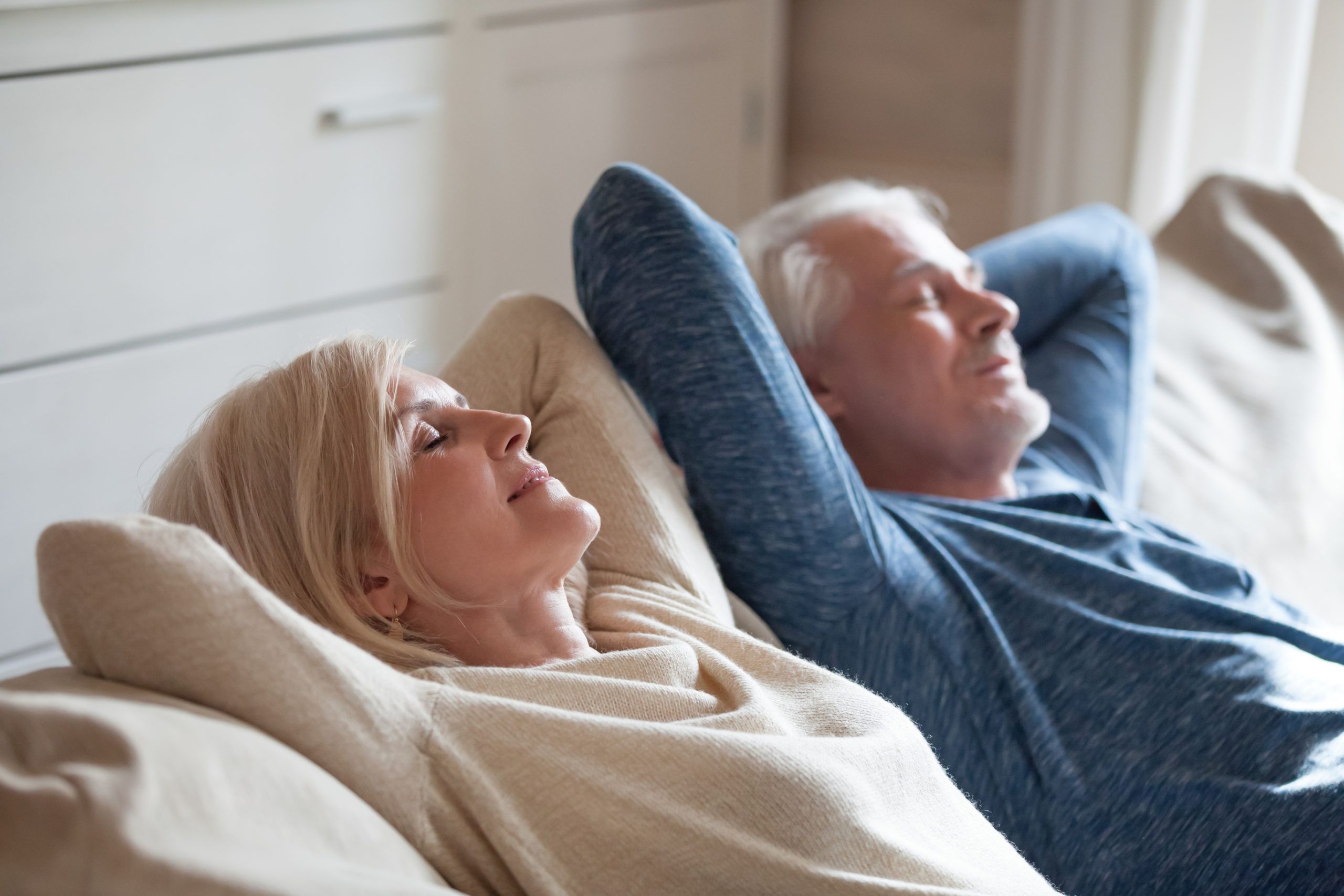 a couple happily relaxing on the couch