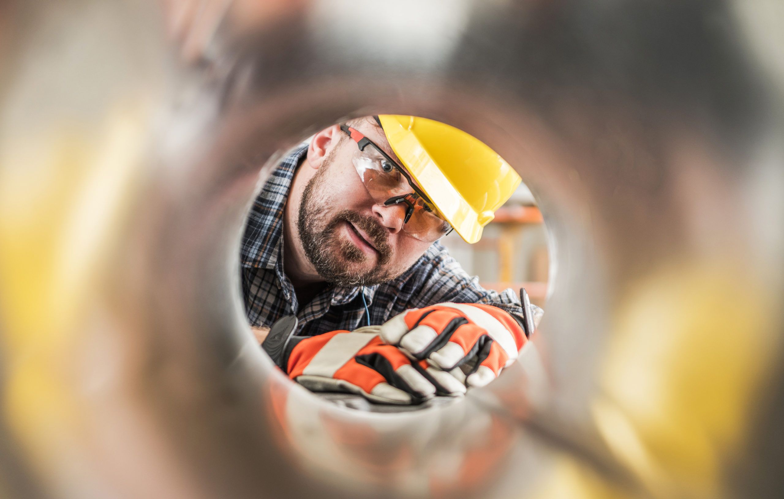 worker seen from inside a tube