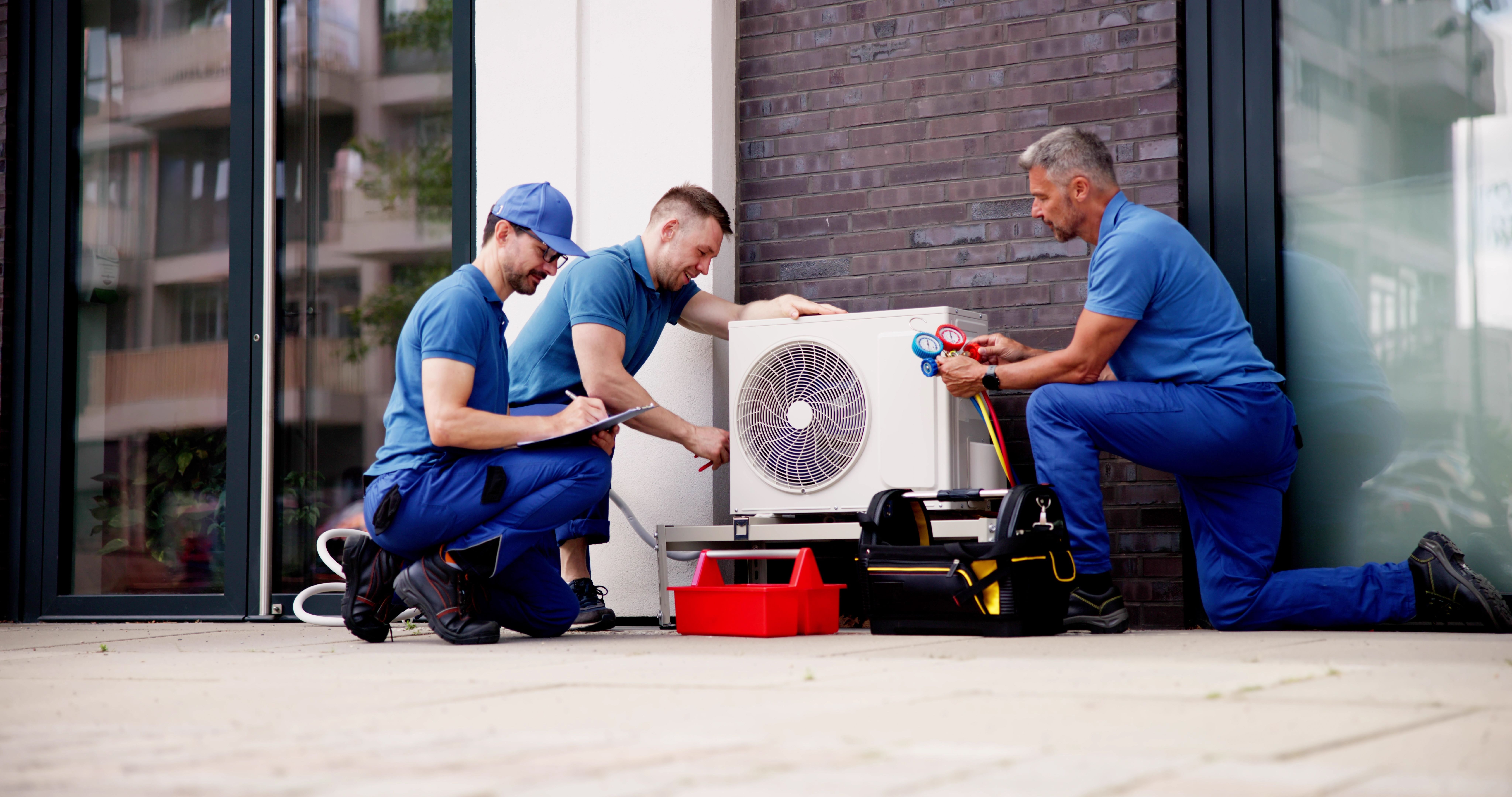 Experienced HVAC Technician Maintaining Commercial Air Conditioner to Ensure Safety and Compliance with Regulations